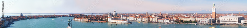 Venice Panorama with the Giudecca Island, the Madonna della Salute Church, Doge's Palace, St. Marc Square seen from the bell tower of the St. George and with the Dolomiti mountains in background