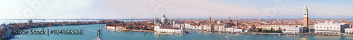 Venice Panorama with the Giudecca Island, the Madonna della Salute Church, Doge's Palace, St. Marc Square seen from the bell tower of the St. George and with the Dolomiti mountains in background