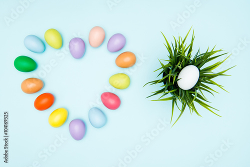Colorful easter eggs on pastel background