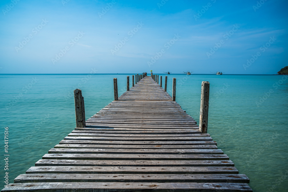Tropical sea and wooden pier, holiday background