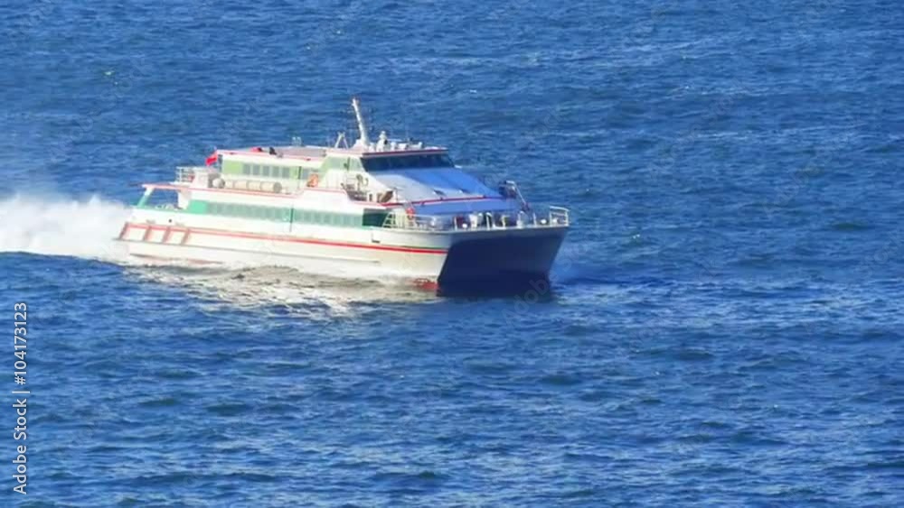 Large passenger catamaran ship entering in port of Hong Kong at sunny day Large passenger catamaran ship entering in port of Hong Kong at sunny day