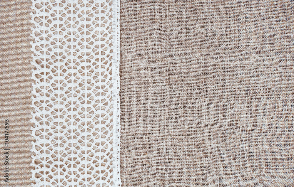 Fototapeta premium Vintage background with lace fabric on burlap cloth