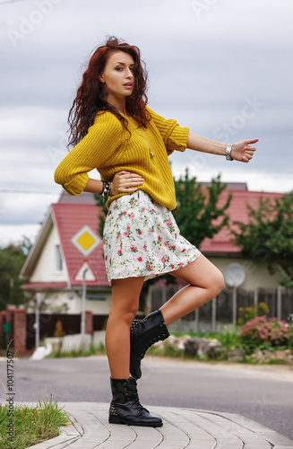 High fashion stylish hipster girl in the yellow sweater outdoor