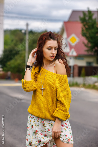 High fashion stylish hipster girl in the yellow sweater outdoor