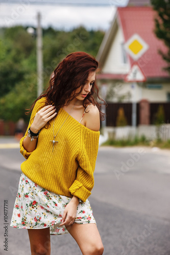 High fashion stylish hipster girl in the yellow sweater outdoor
