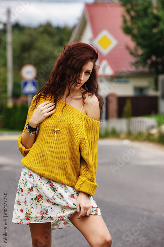 High fashion stylish hipster girl in the yellow sweater outdoor
