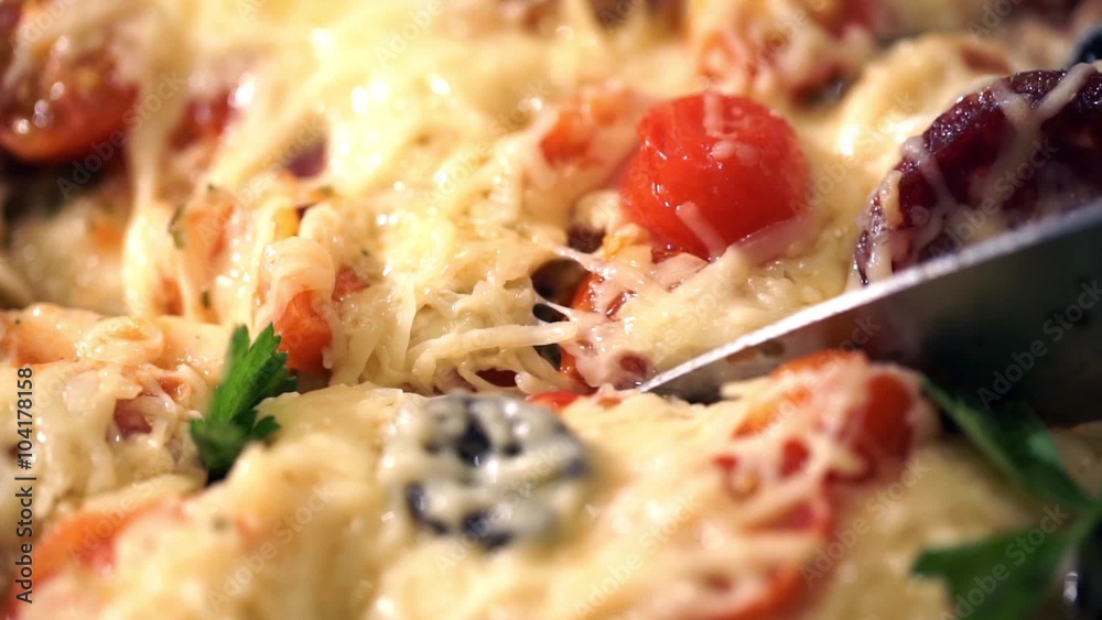 Pizza with ham, tomato and olives. Macro shot.