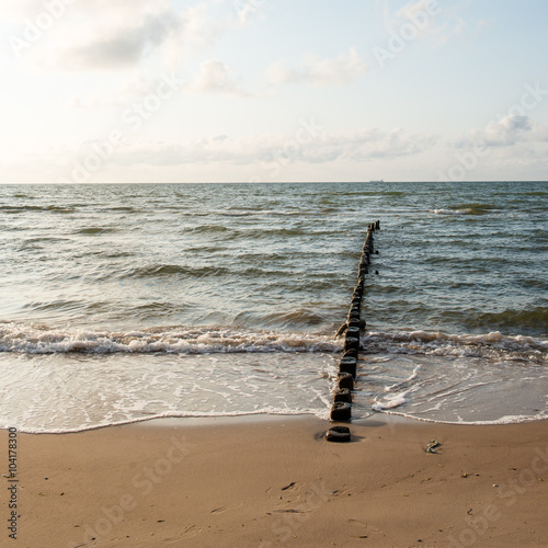 Breakwater of one row of wooden poles at the Sea coast