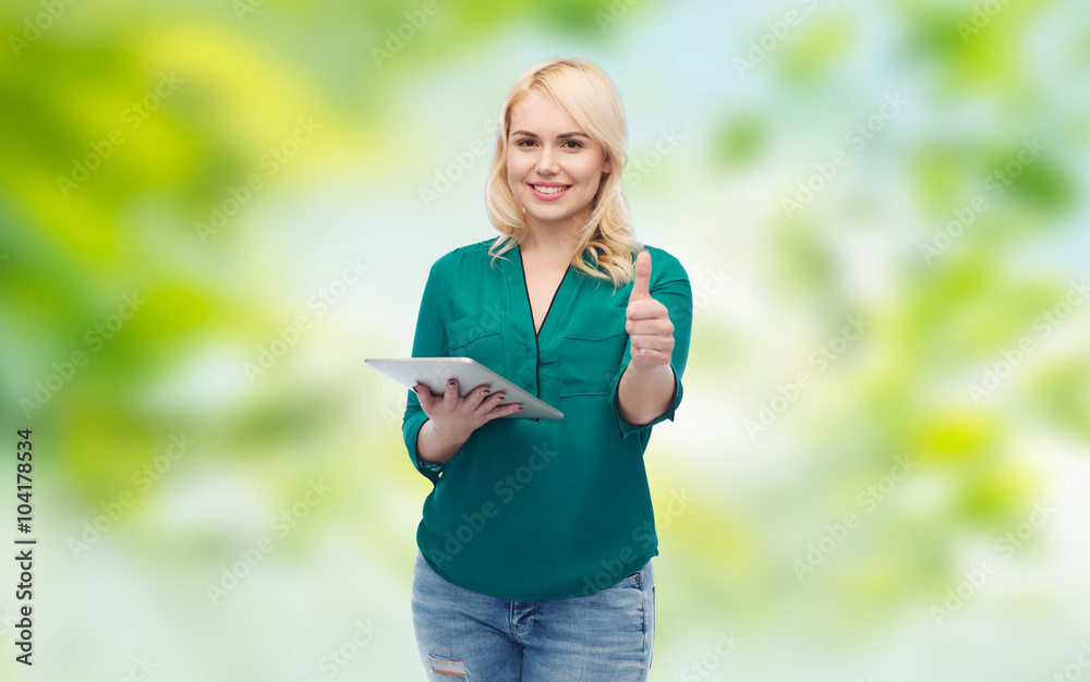 smiling woman with tablet pc showing thumbs up smiling woman with tablet pc showing thumbs up