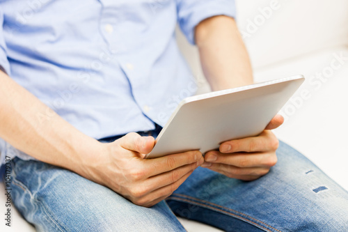 close up of man working with tablet pc at home © Syda Productions