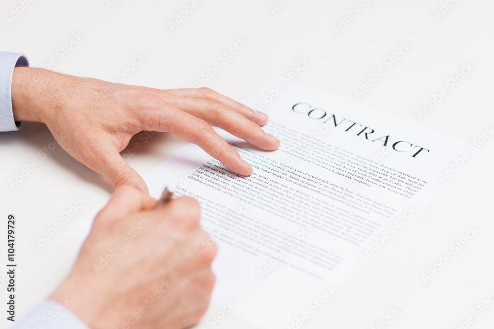 close up of male hands signing contract document close up of male hands signing contract document