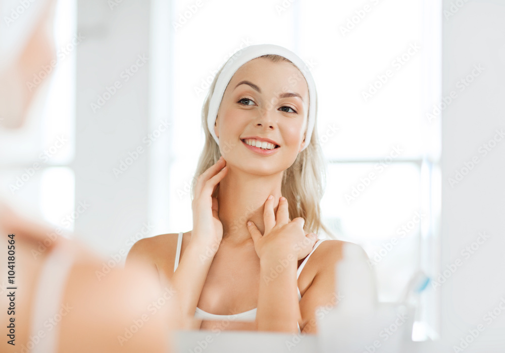 woman in hairband touching her face at bathroom woman in hairband touching her face at bathroom