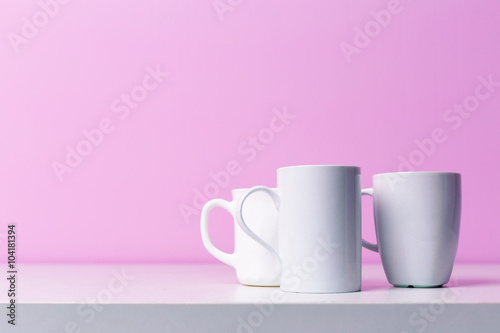 Cups on lilac background