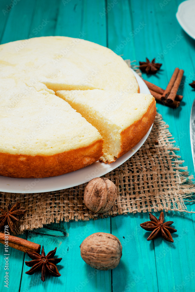 Fototapeta premium pastries, desserts , curd pudding with milk,cottage cheese casserole , cinnamon and nuts on a wooden background