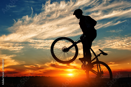 Silhouette of a man on muontain-bike