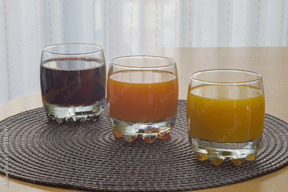 Multi fruit citrus juice from oranges, lemons, bananas, grapes in a glass Multi fruit citrus juice from oranges, lemons, bananas, grapes in a glass