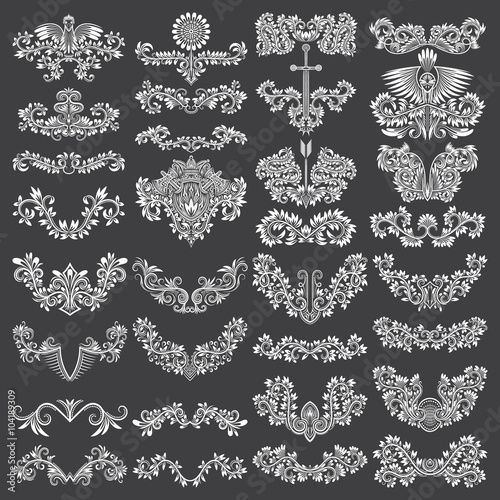 Big set of ornamental elements for design. White floral decorations on black. Isolated tattoo patterns in vintage style. Vintage page ornate decorations.