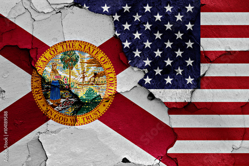 flags of Florida and USA painted on cracked wall
