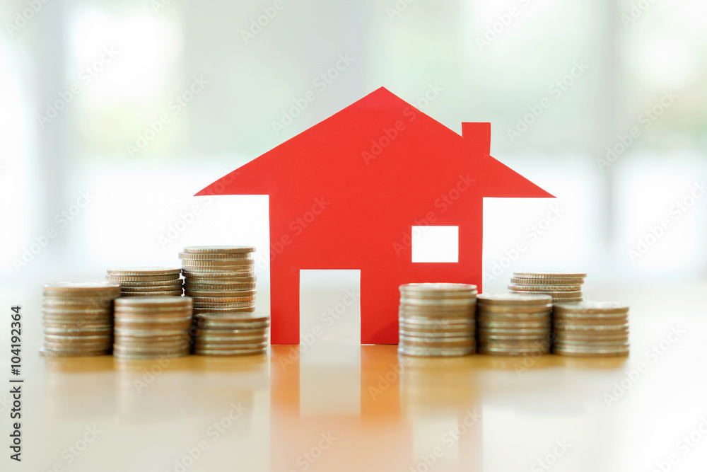 Mortgage concept by money house from the coins Mortgage concept by money house from the coins