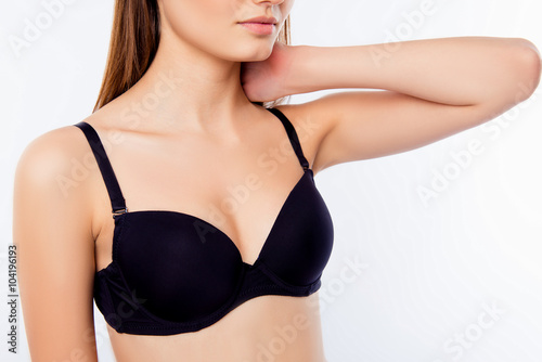 Close up portrait of girl in black bra touching her neck