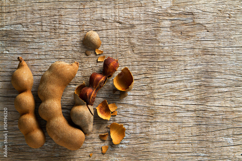 Sweet tamarinds on wooden background.