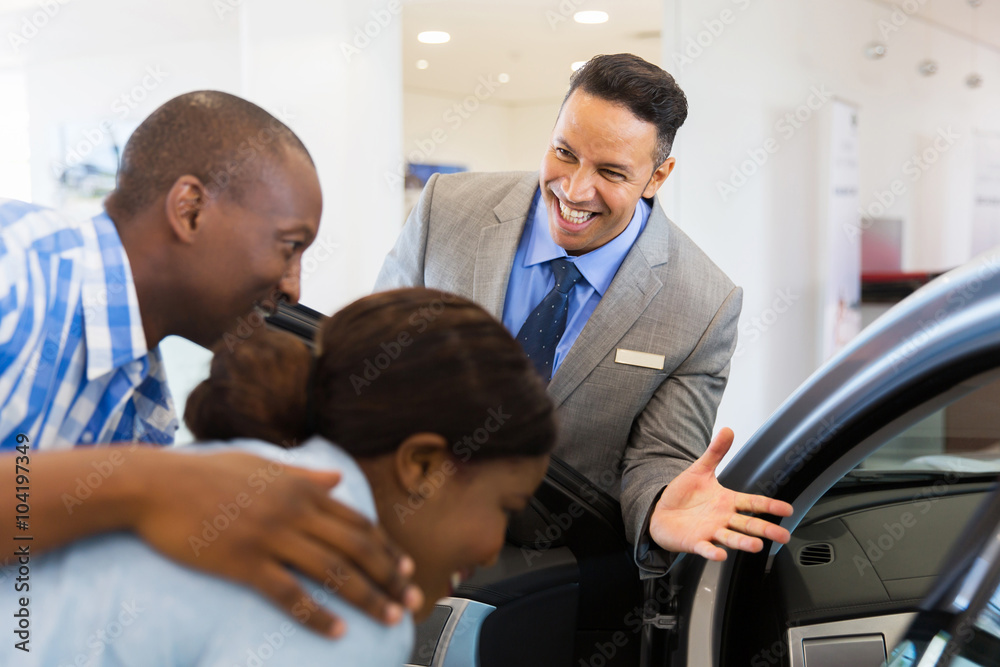 vehicle dealer selling new car to young couple vehicle dealer selling new car to young couple