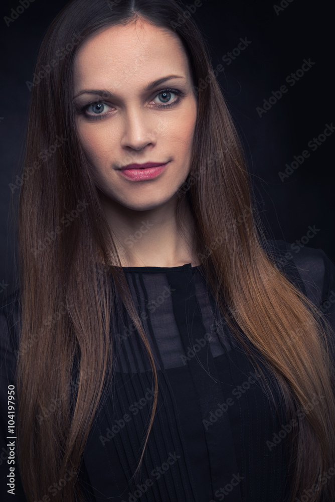 beautiful young woman on a dark background