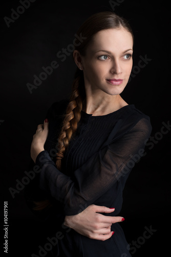 beautiful young woman on a dark background