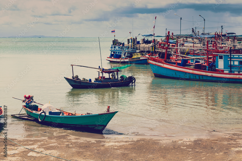 Old Harbour with fishing boats, ship and docks in Thailand.