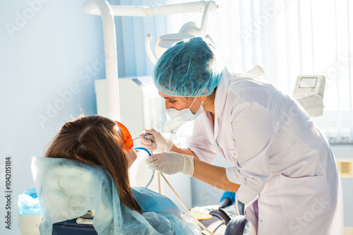 woman dentist at work with patient