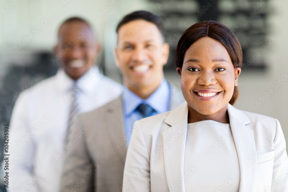 african businesswoman with colleagues standing in a row african businesswoman with colleagues standing in a row