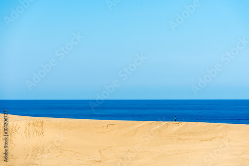 yellow sand and blue sea and sky