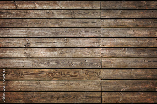 Part of old wooden pier made from planks.