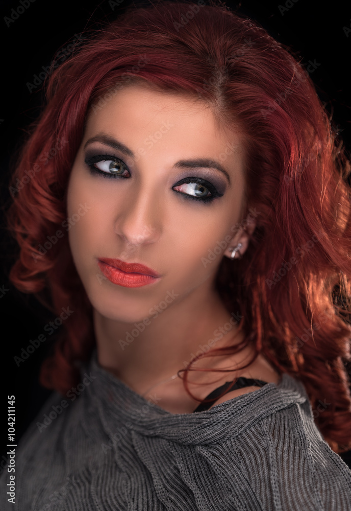 Portrait of beautiful redheaded woman looking apart with very nice green eyes