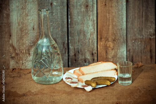 Vodka decanter, and snack (fat, bread and pickle) in the Ukraini photo