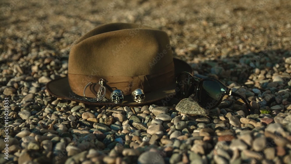 hat and sunglasses lying on the beach hat and sunglasses lying on the beach