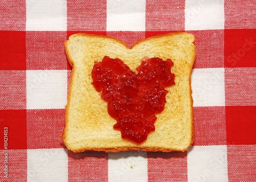 Jelly spread in a heart shape on a piece of toast