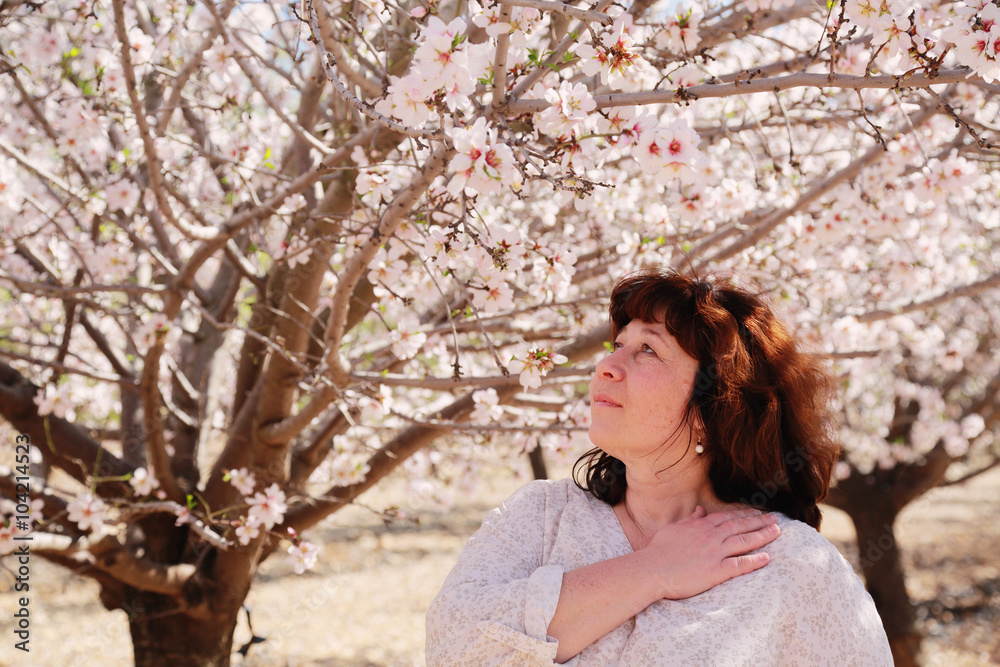 Beautiful real 45 years old woman standing in the park Beautiful real 45 years old woman standing in the park