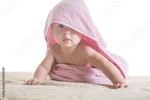 Sweet small baby covered with a towel