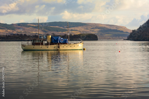 old steam boat anchored in calm water