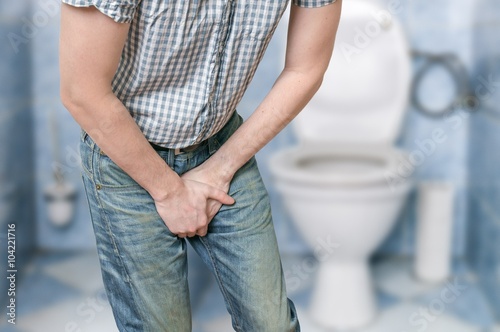 Cuadro en lienzo Man with prostate problem in front of toilet bowl