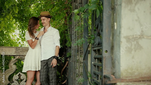young woman and man talking on green plants 