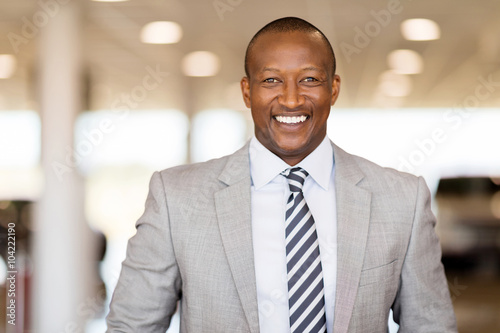 african car salesman in showroom