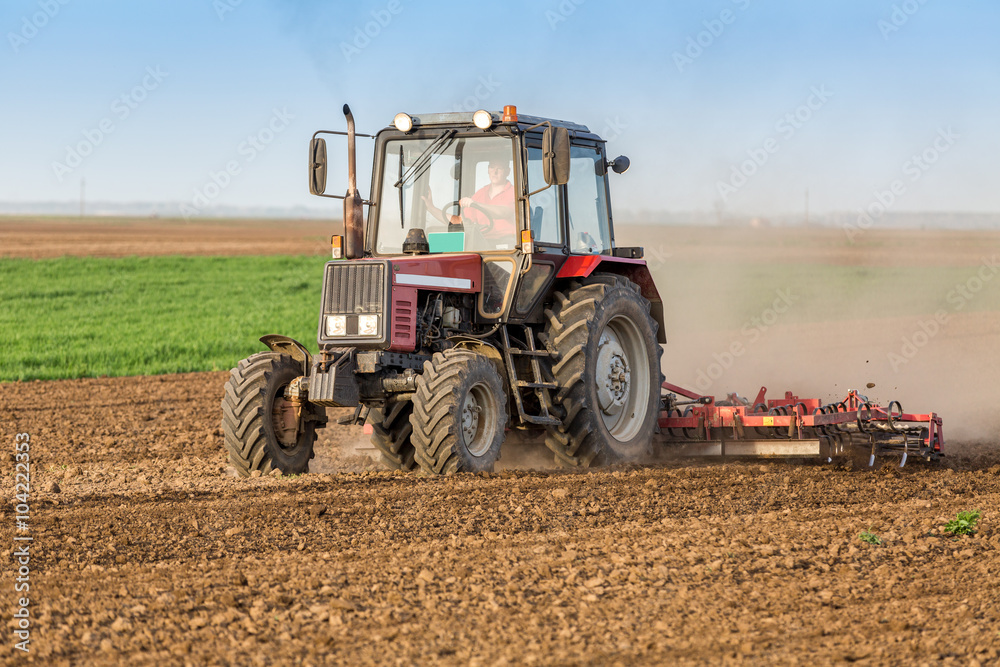 Farmer cultivating arable land before seeding Farmer cultivating arable land before seeding