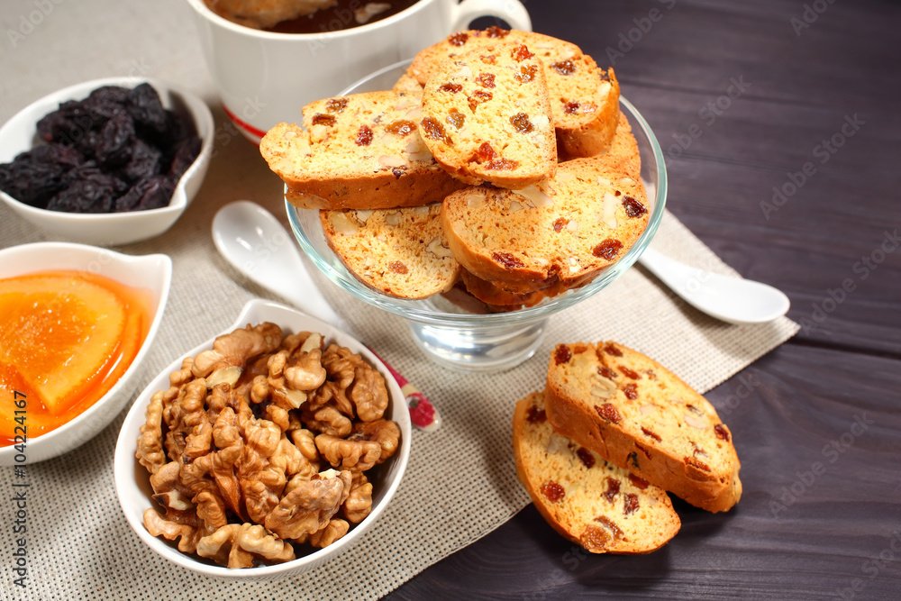 Homemade biscotti are laid out in the form of words next to a large cup of hot black coffee on vintage rustic table Homemade biscotti are laid out in the form of words next to a large cup of hot black coffee on vintage rustic table