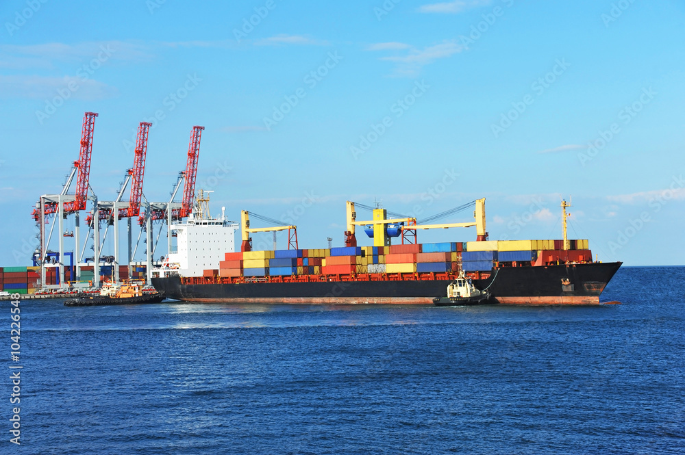 Tugboat assisting container cargo ship Tugboat assisting container cargo ship