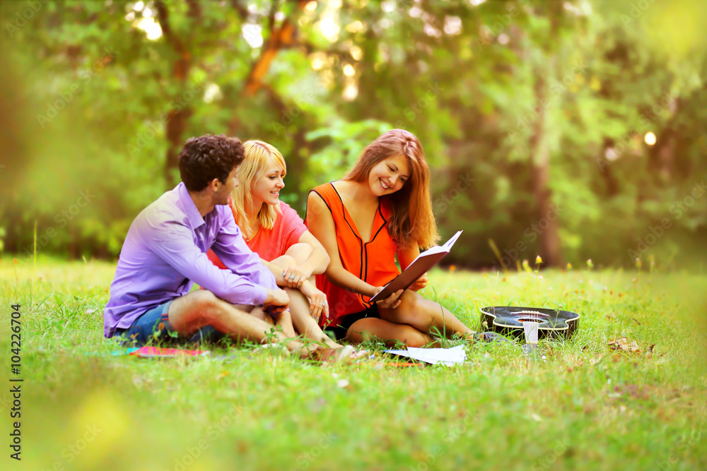 the successful group of students with notebooks in a Park