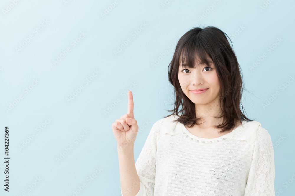 attractive asian woman on blue background attractive asian woman on blue background