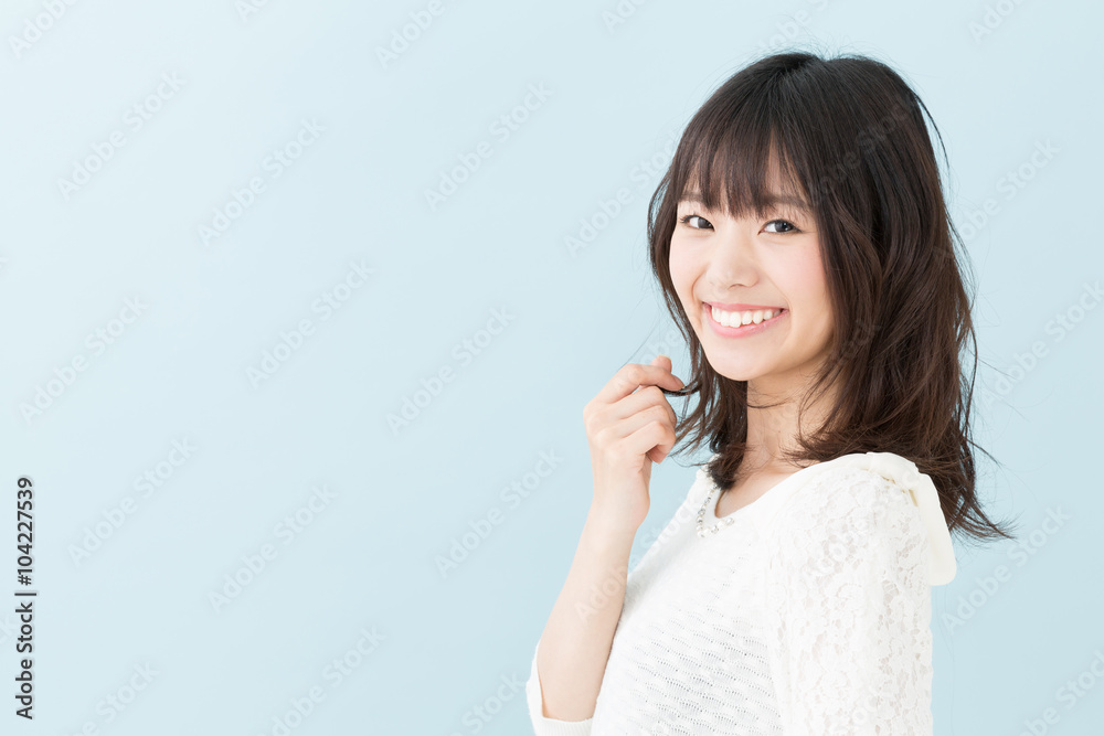 attractive asian woman on blue background attractive asian woman on blue background