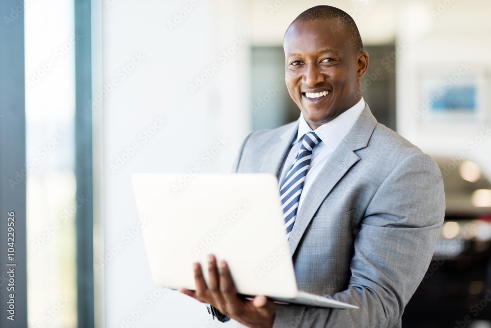 afro american vehicle sales consultant using laptop afro american vehicle sales consultant using laptop